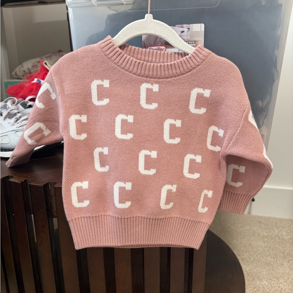 Pink Sweater with White Lettering